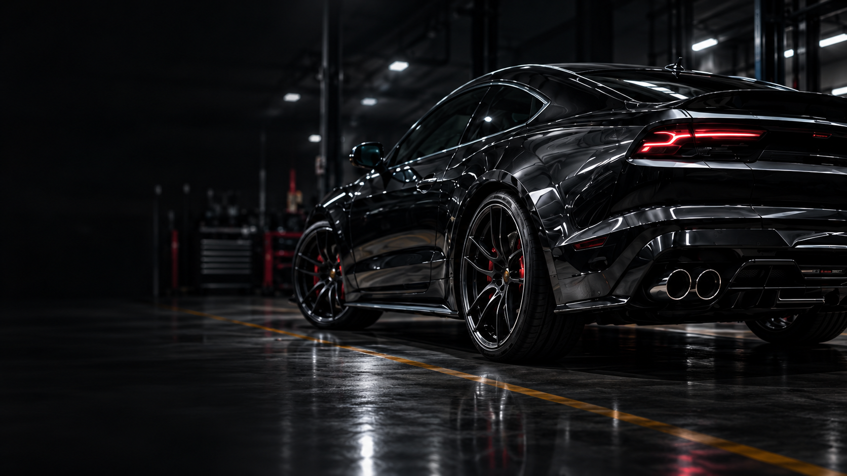 Black performance car in a workshop